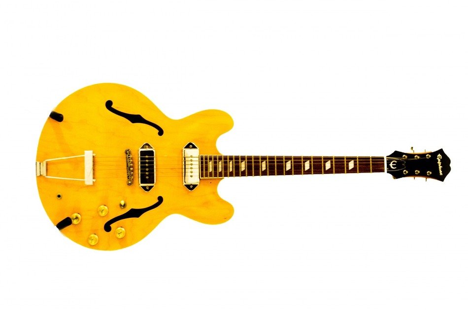 Yellow guitar on white background