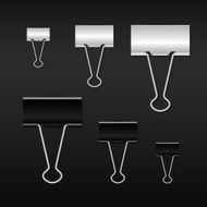 Binder clips for paper on dark background