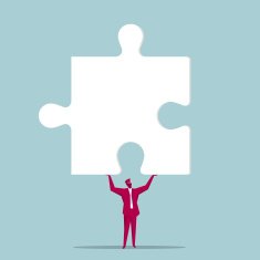 Businessman Holding Up a Jigsaw Puzzle