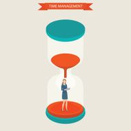 Business women holding laptop standing at hourglass