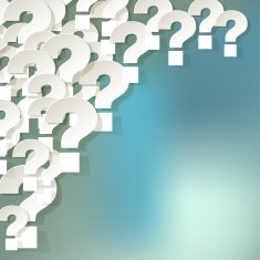 White paper question marks in the corner on bokeh background