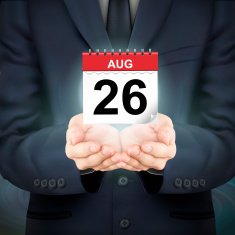 businessman holding a small calendar