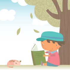 Little boy reading under the tree