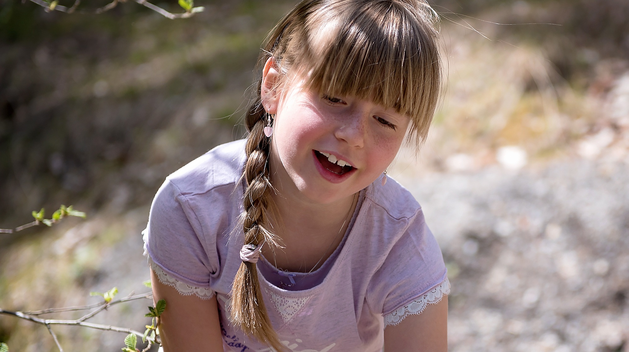 Little girl with a scythe on the nature image 