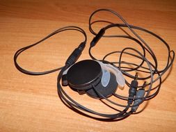 round black headphones on a wooden table