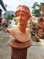 orange bust on a pedestal in Italy