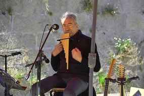 street musician plays a pan flute