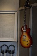 old electric guitar hangs in studio