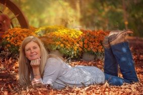 girl lies on yellow leaves