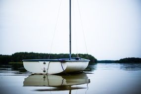 reflection of a sailboat on the water