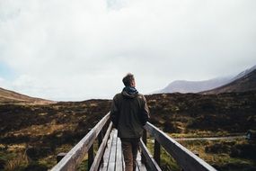 man on a wooden bridge