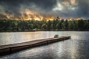 wooden pier on the lake sunset