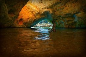 Girl in a bikini in a grotto