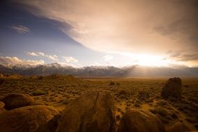 rocks boulders at desert, mountains on skyline, landscape