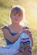 Girl with white hair in the rays of sunlight
