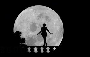 silhouette of a woman on a background of the moon