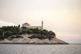 lighthouse on an island near the water