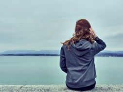 brunette girl looking at the water