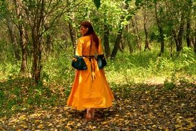 girl in a yellow princess dress in the forest