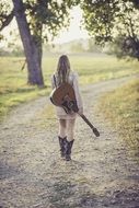 country girl with guitar on the road