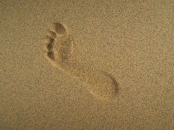 human footprint on yellow sand