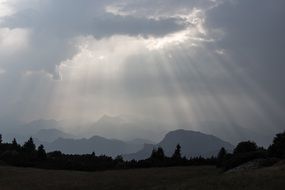 sun's rays through the clouds on the mountains