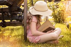 Girls in hat with book
