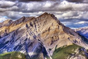 massive mountains under a cloudy sky
