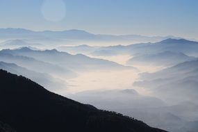 panoramic view of the mystical mountain valleys in the fog