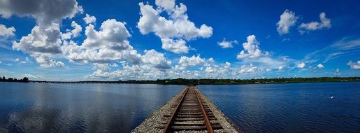 rusty train tracks on bridge above water, usa, florida, oldsmar