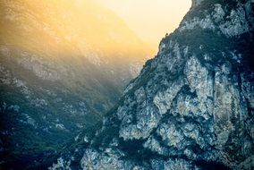 Landscape of the beautiful mountain in fog in colorful sunshine