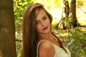 portrait of a girl in a white dress on a background of autumn forest