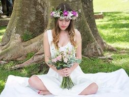 girl with flowers by tree