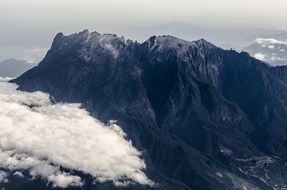 mountain top behind the clouds