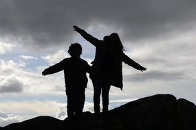 silhouettes of happy people at sunset