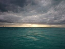 blue ocean water and cloudy sky