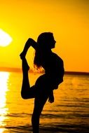 exercising woman at sunset