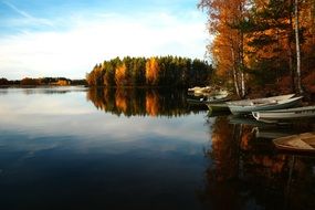 standing empty boats on the river bank
