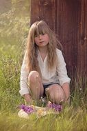 Little girl with long hair in nature