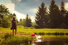 girls fishing near lake scene