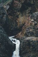 Beautiful mountain waterfall in colorful stones