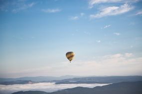 A large balloon against the backdrop of picturesque nature