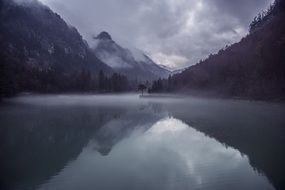 mountains near the lake in the fog