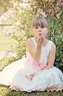 Little girl in a smart dress among nature