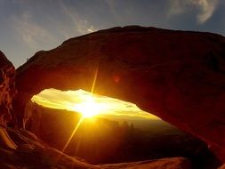 scenic landscape of sunset through stone arch