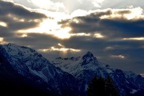 Mountain snow-capped peaks against the background of the sunrise