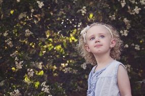 blonde curly girl in nature