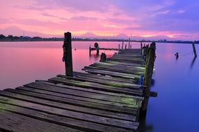old pier on the background of pink sunset