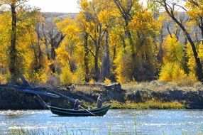 fishing boat in thriver in autumn