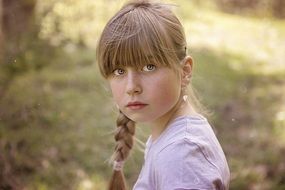Little girl with a slanting and expressive look